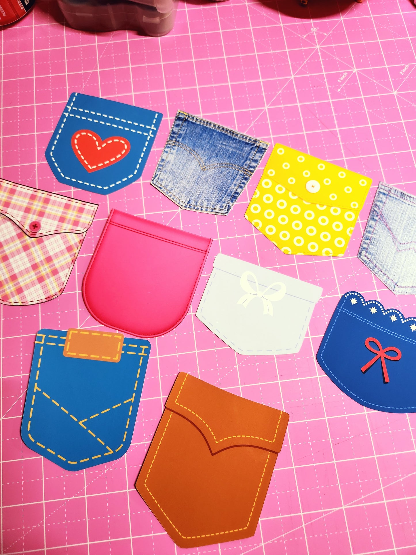 Colorful fabric patches on a pink grid background