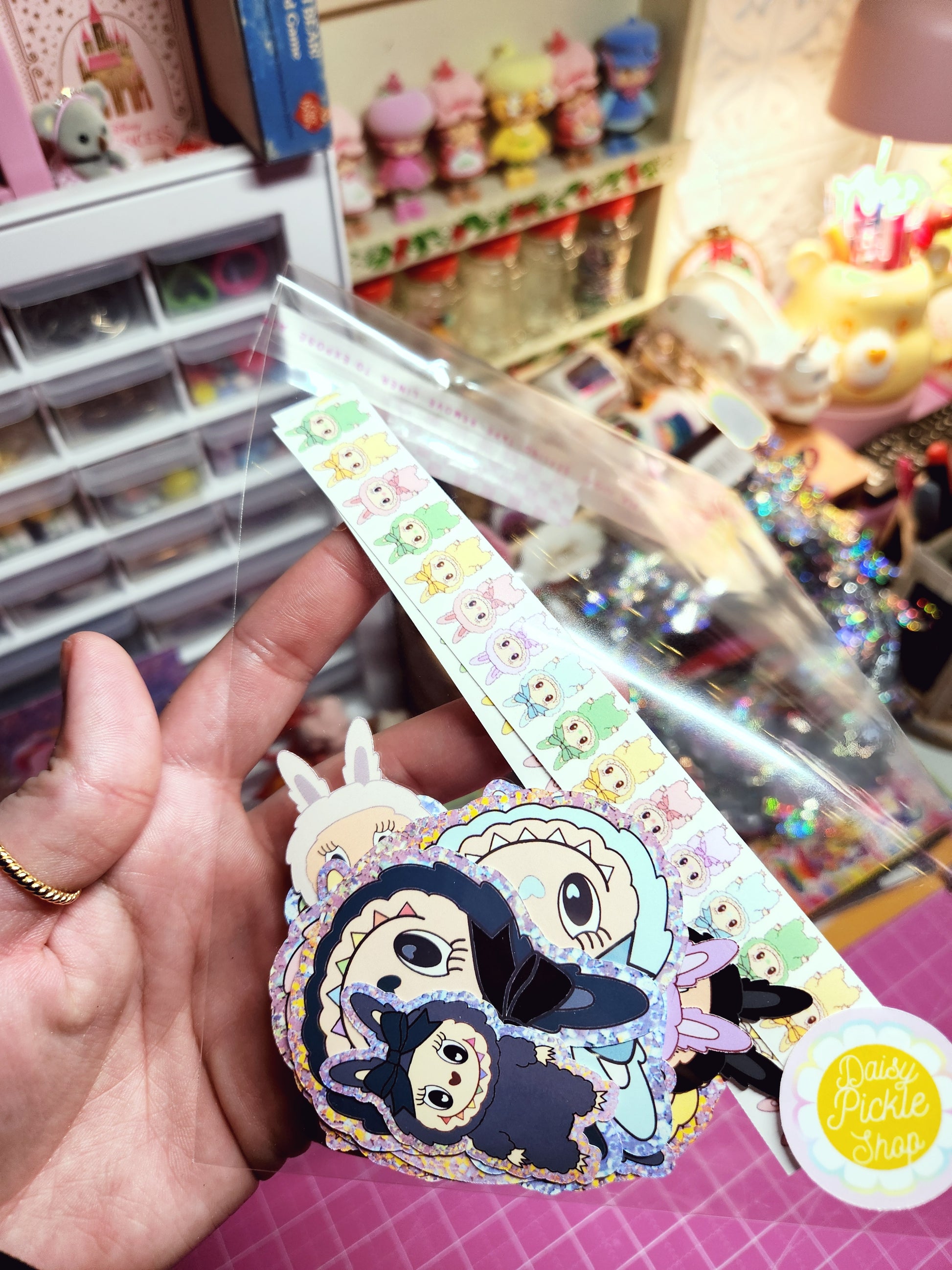 Decorative ribbon with cartoon character design held by a hand in a store setting.