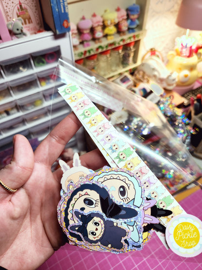 Decorative ribbon with cartoon character design held by a hand in a store setting.