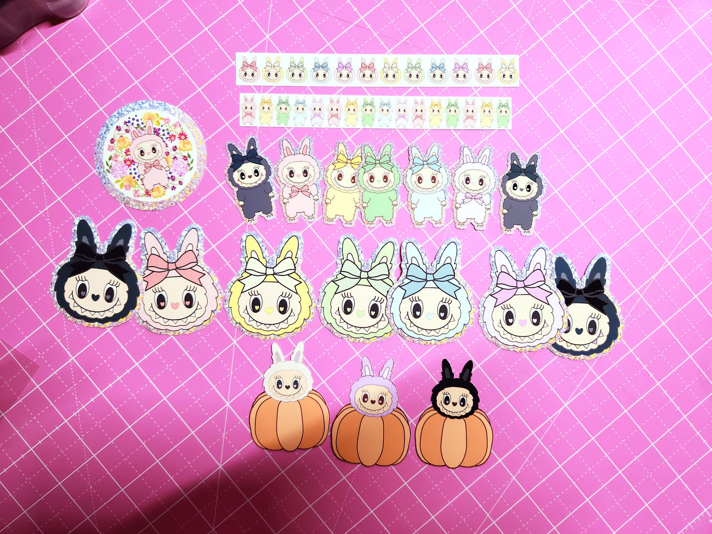 Collection of cartoon character stickers on a pink grid background