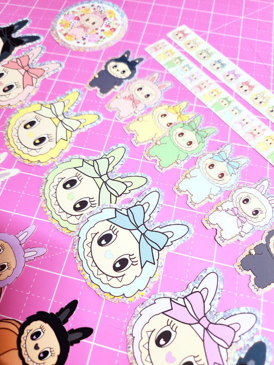 Cartoon character stickers on a pink grid background
