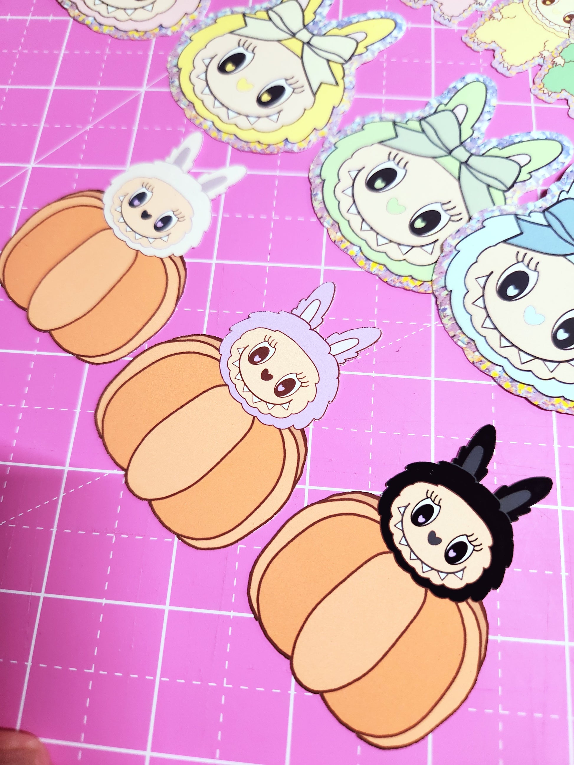 Cartoon characters with pumpkin hats on a pink grid background