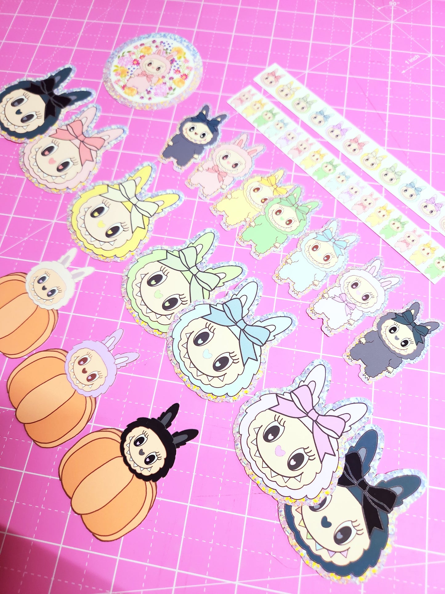 Cartoon character stickers on a pink grid background