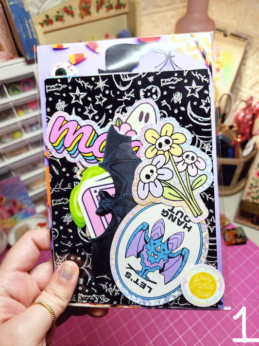 Decorative phone case with colorful designs and text held by a hand.