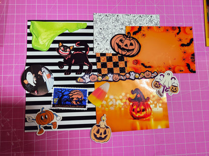 Collection of Halloween-themed stickers on a pink cutting mat with grid lines.