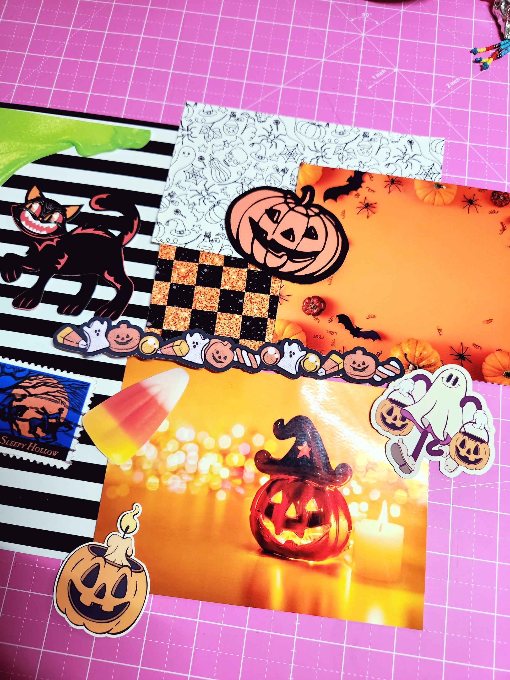 Halloween-themed stickers on a pink grid background