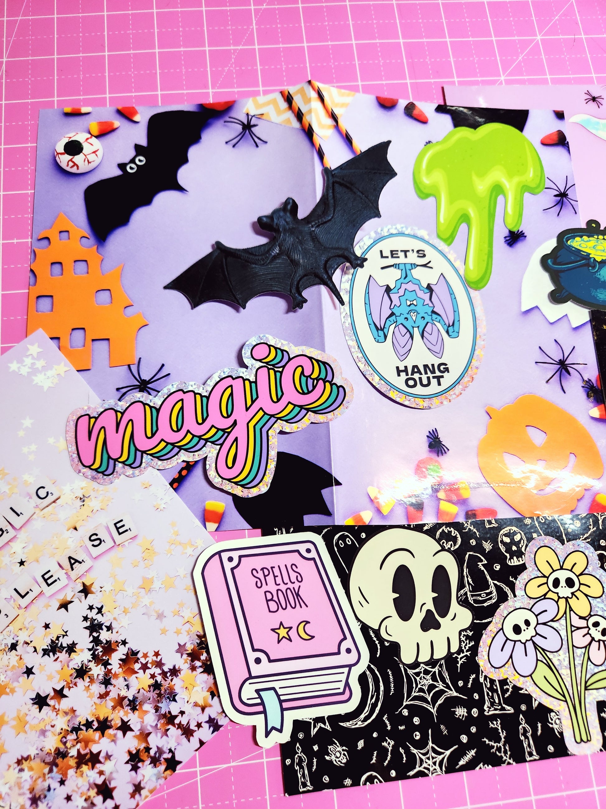 Collection of colorful Halloween-themed stickers on a pink background