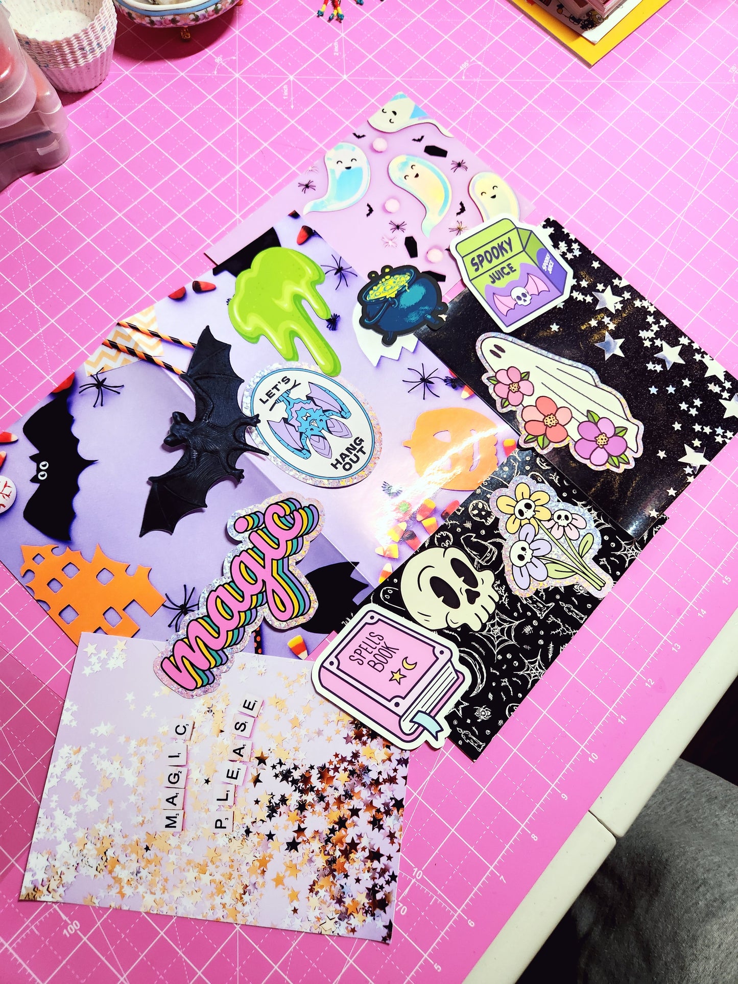 Colorful Halloween-themed stickers on a pink cutting mat