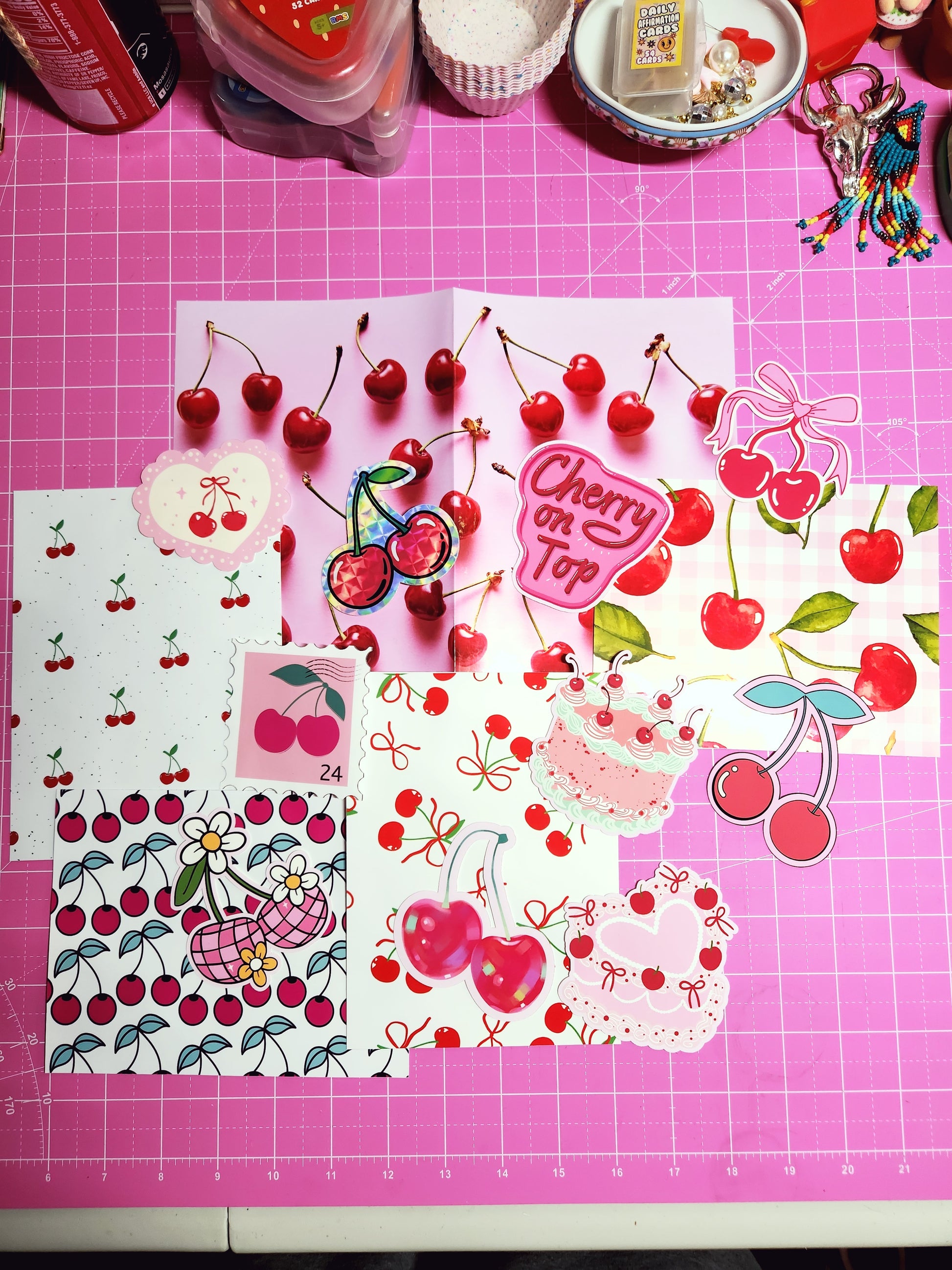 Decorative paper with cherry designs on a pink cutting mat