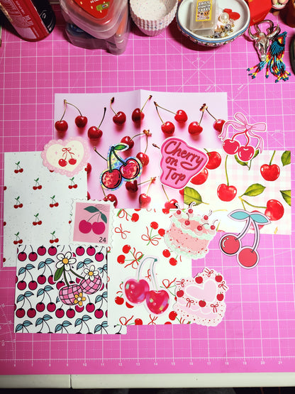 Decorative paper with cherry designs on a pink cutting mat
