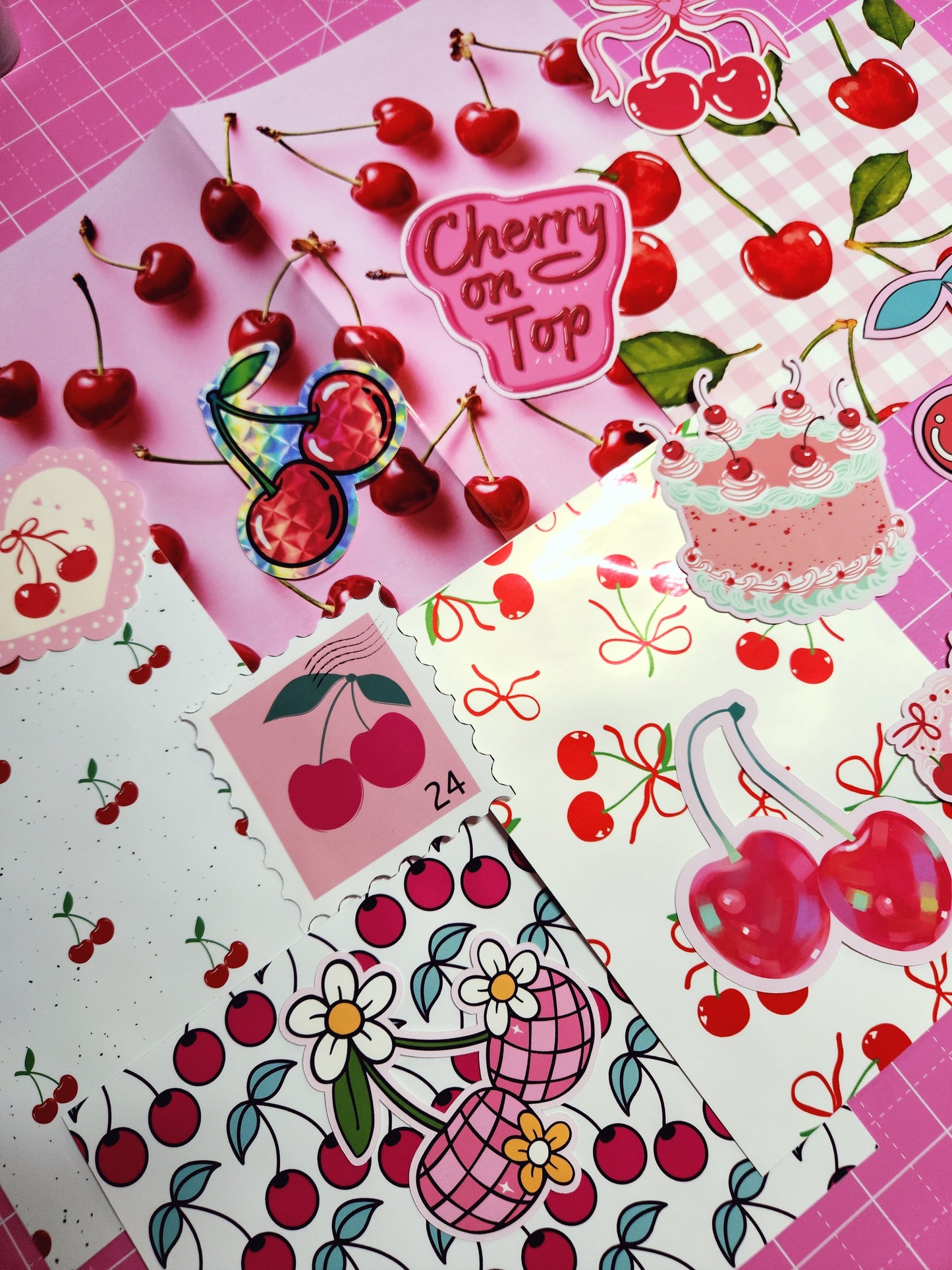 Collection of cherry-themed stickers on a pink grid background
