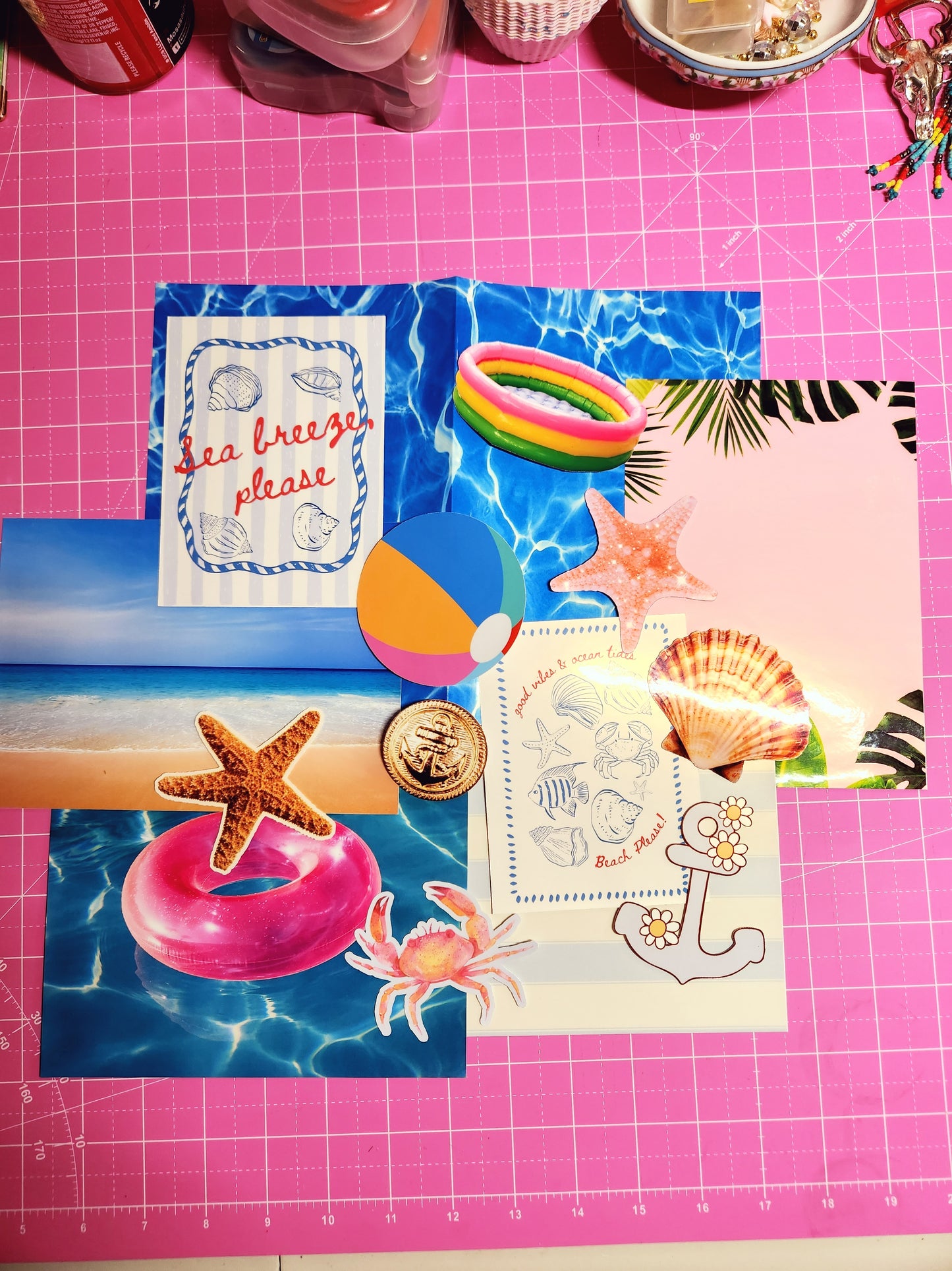 Collection of beach-themed cards and stickers on a pink cutting mat.