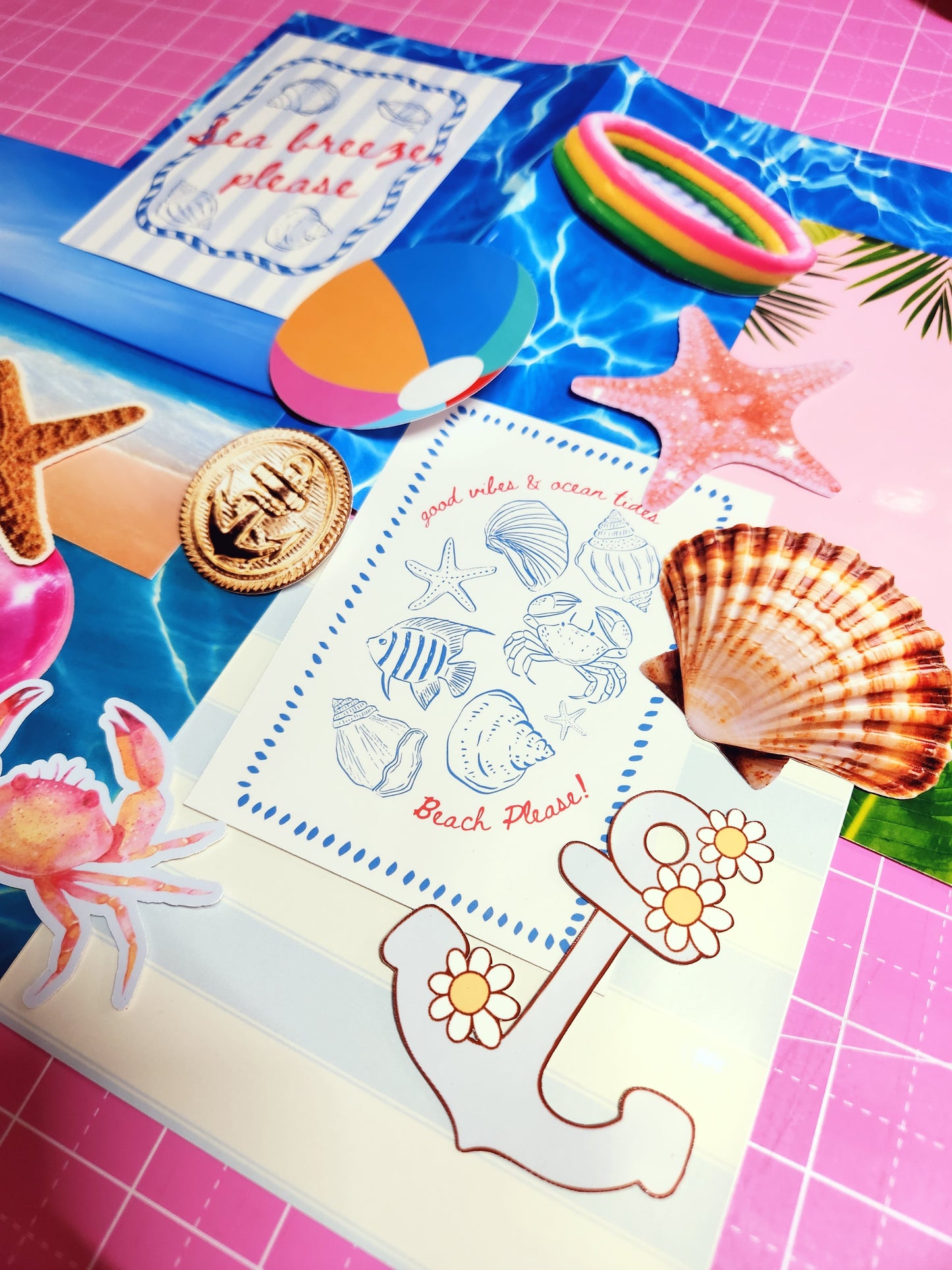 Coloring book with beach-themed stickers and a gold coin on a pink grid background