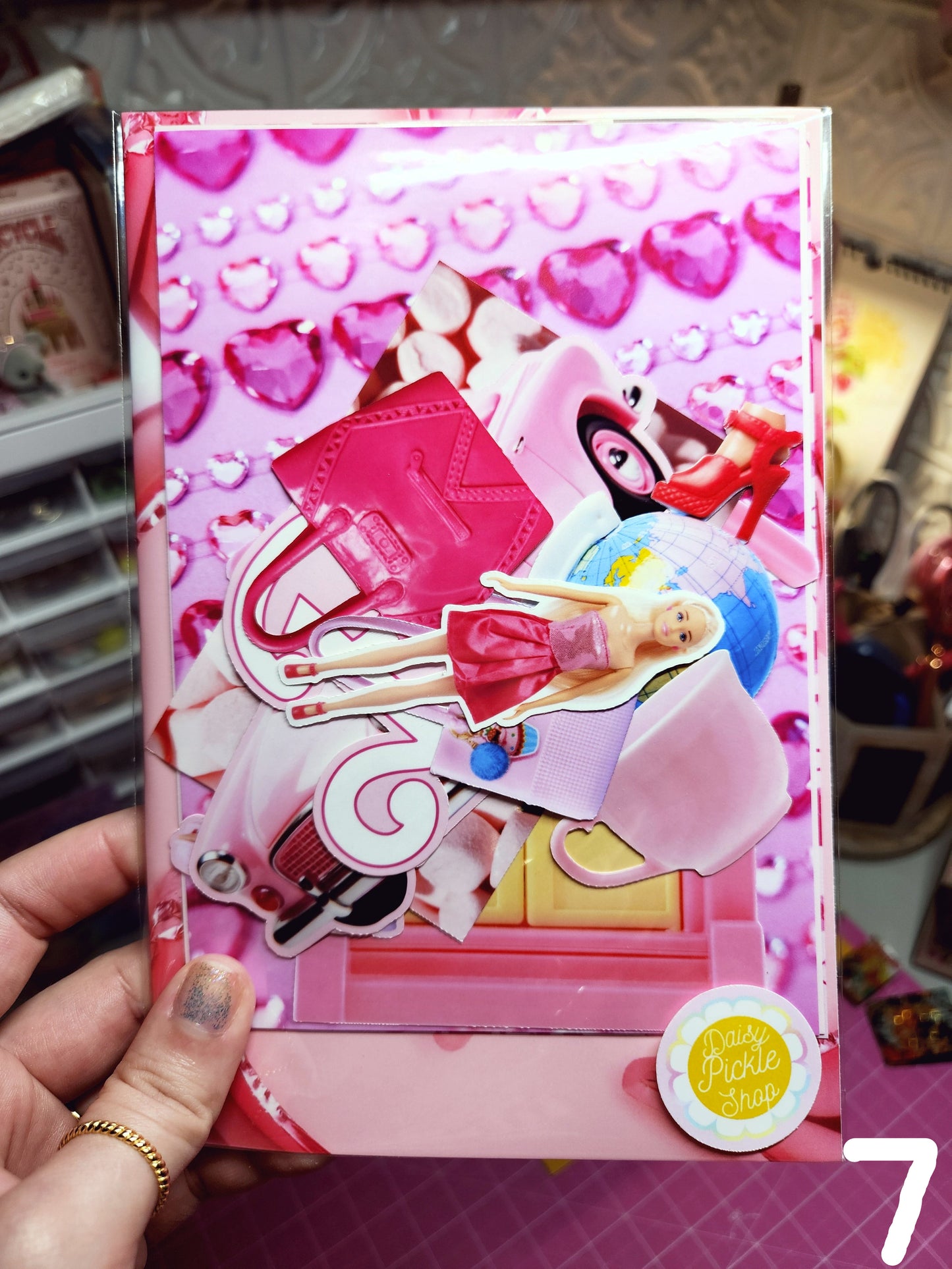 Toy box with a Barbie-themed design held by a hand.
