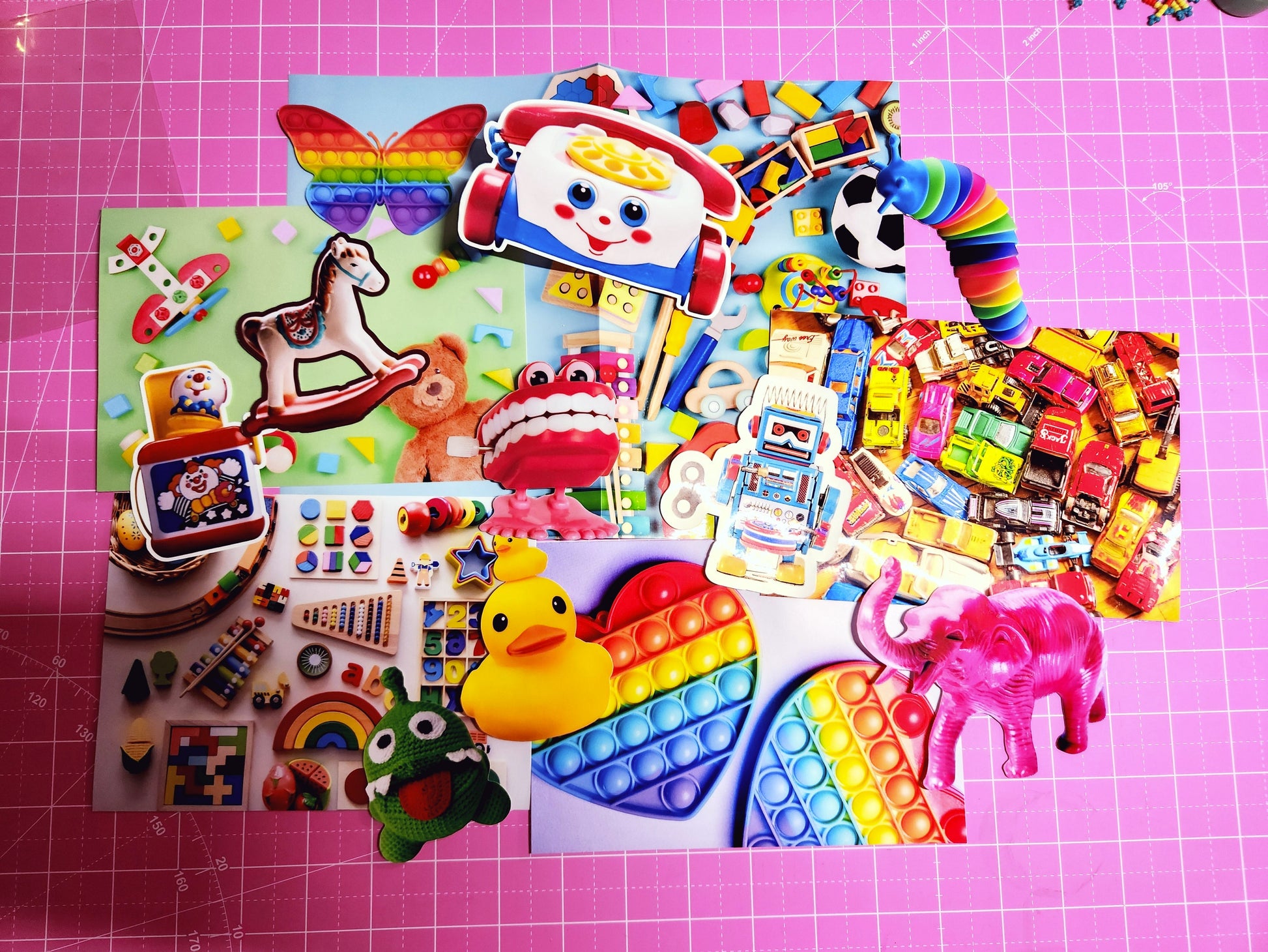 Assorted colorful toys and fidget items on a pink grid background