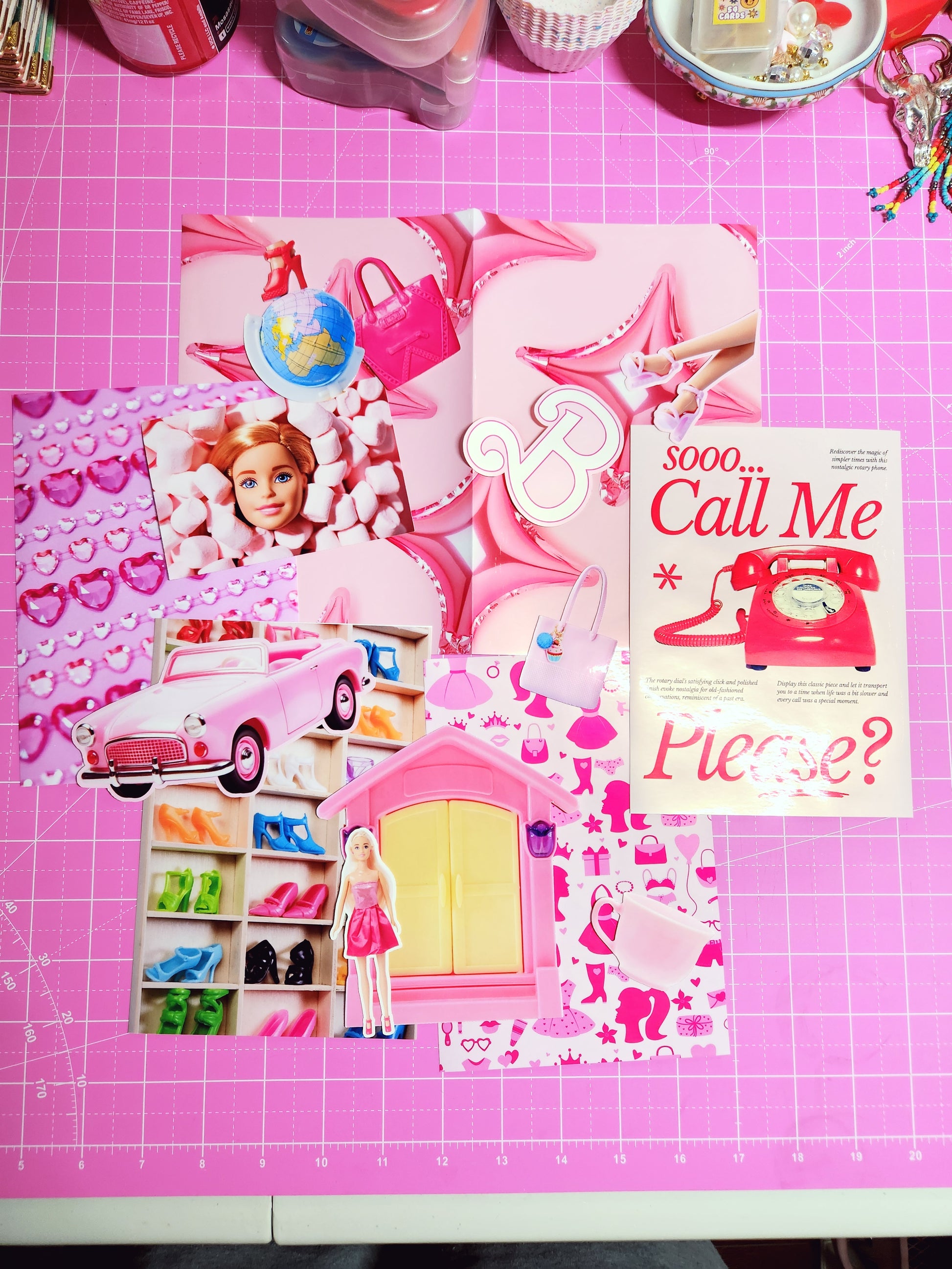Stationery items including a notebook, stickers, and clips on a pink grid background
