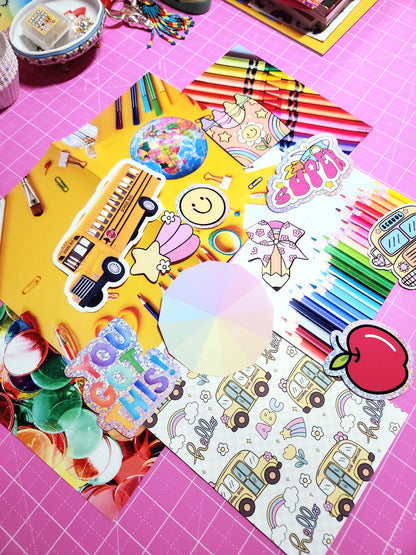 Colorful stationery items including crayons, stickers, and a coloring book on a pink grid background.