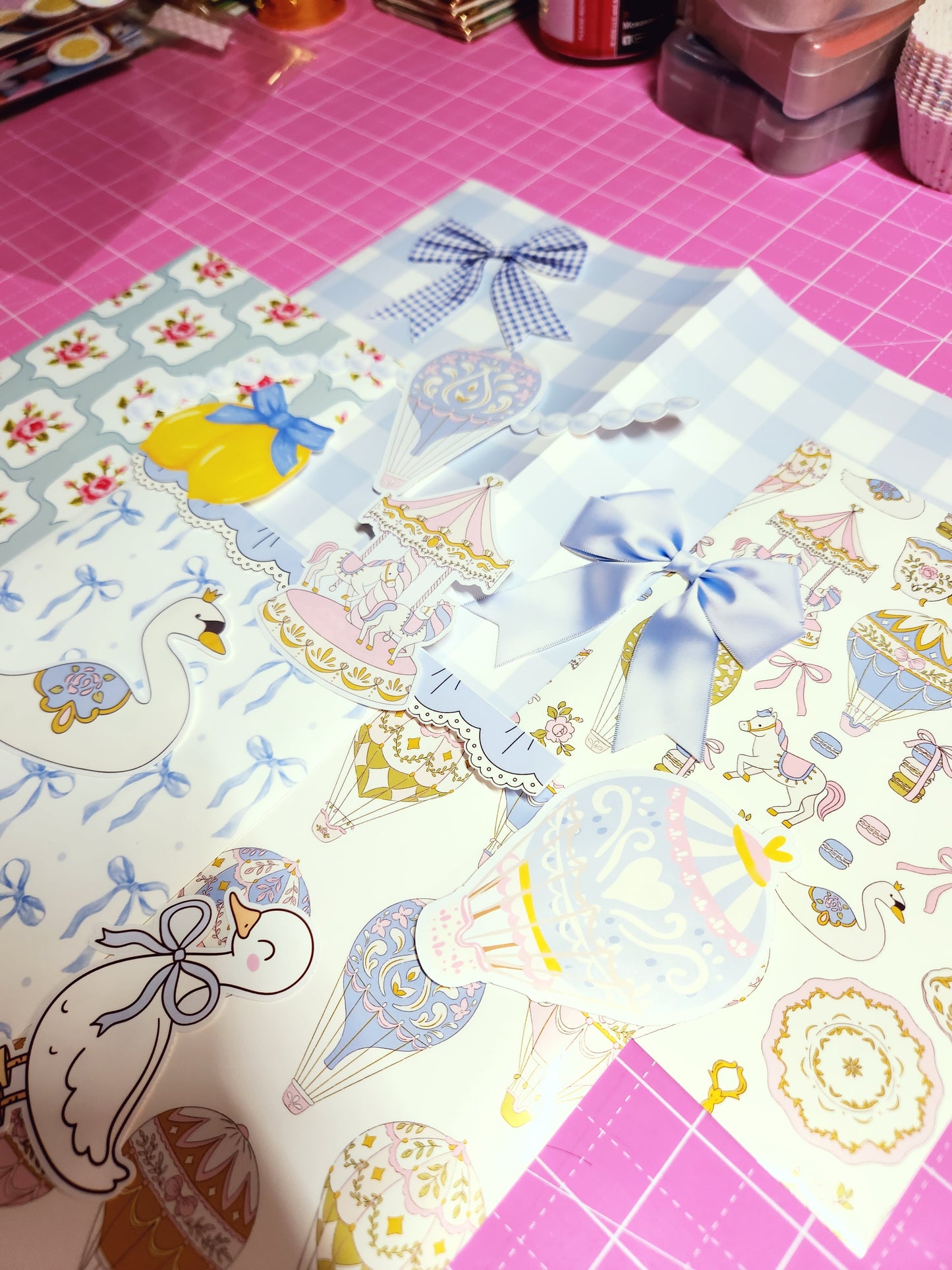 Decorative paper with cartoon swans and bows on a pink grid background