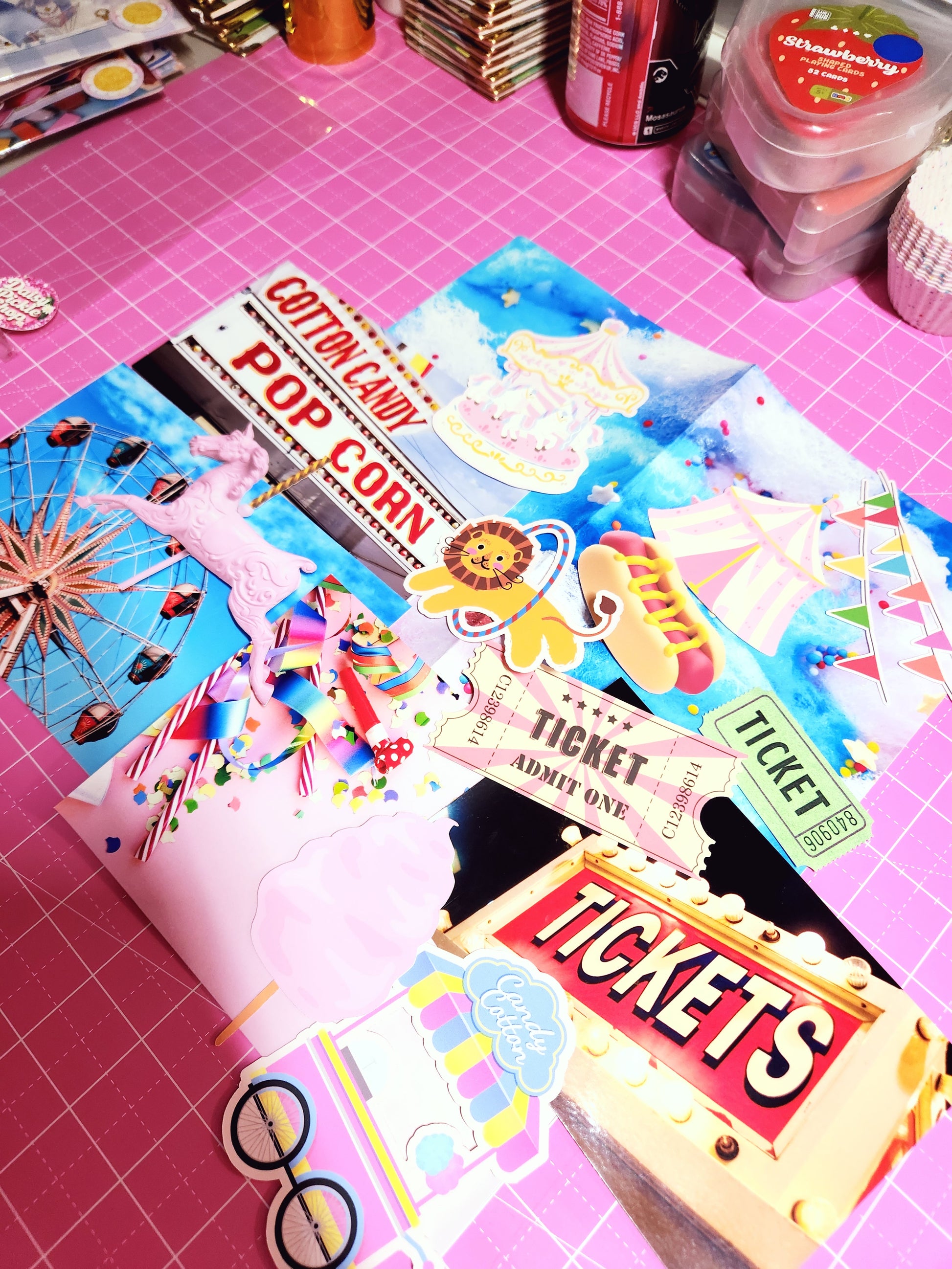 Colorful paper cutouts of movie theater-themed items on a pink surface.