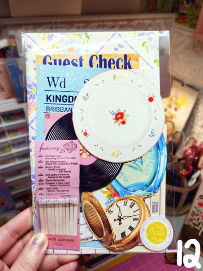 Product packaging with decorative elements and text, held by a hand.