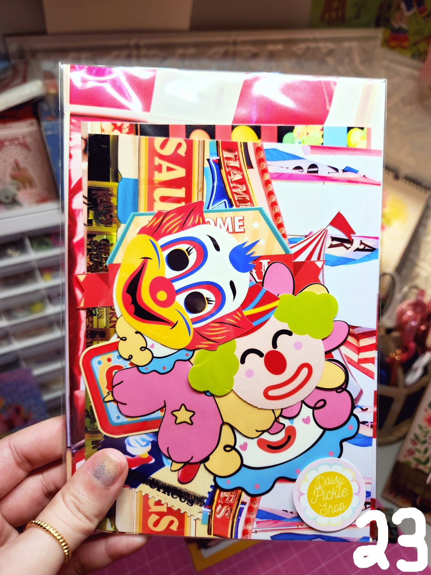 Colorful box with cartoon characters and text, held by a hand.