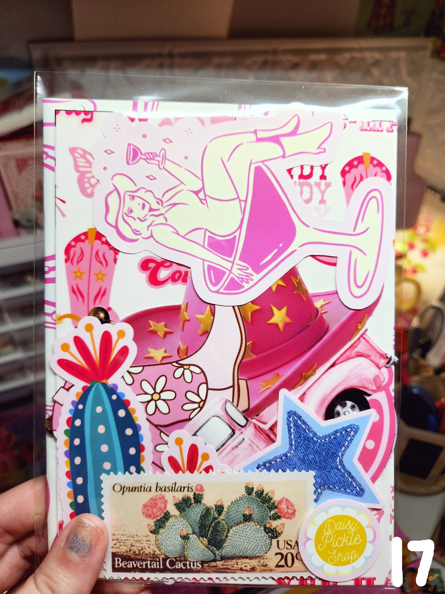 Colorful stationery set with various items including stickers and a pen, held by a person.