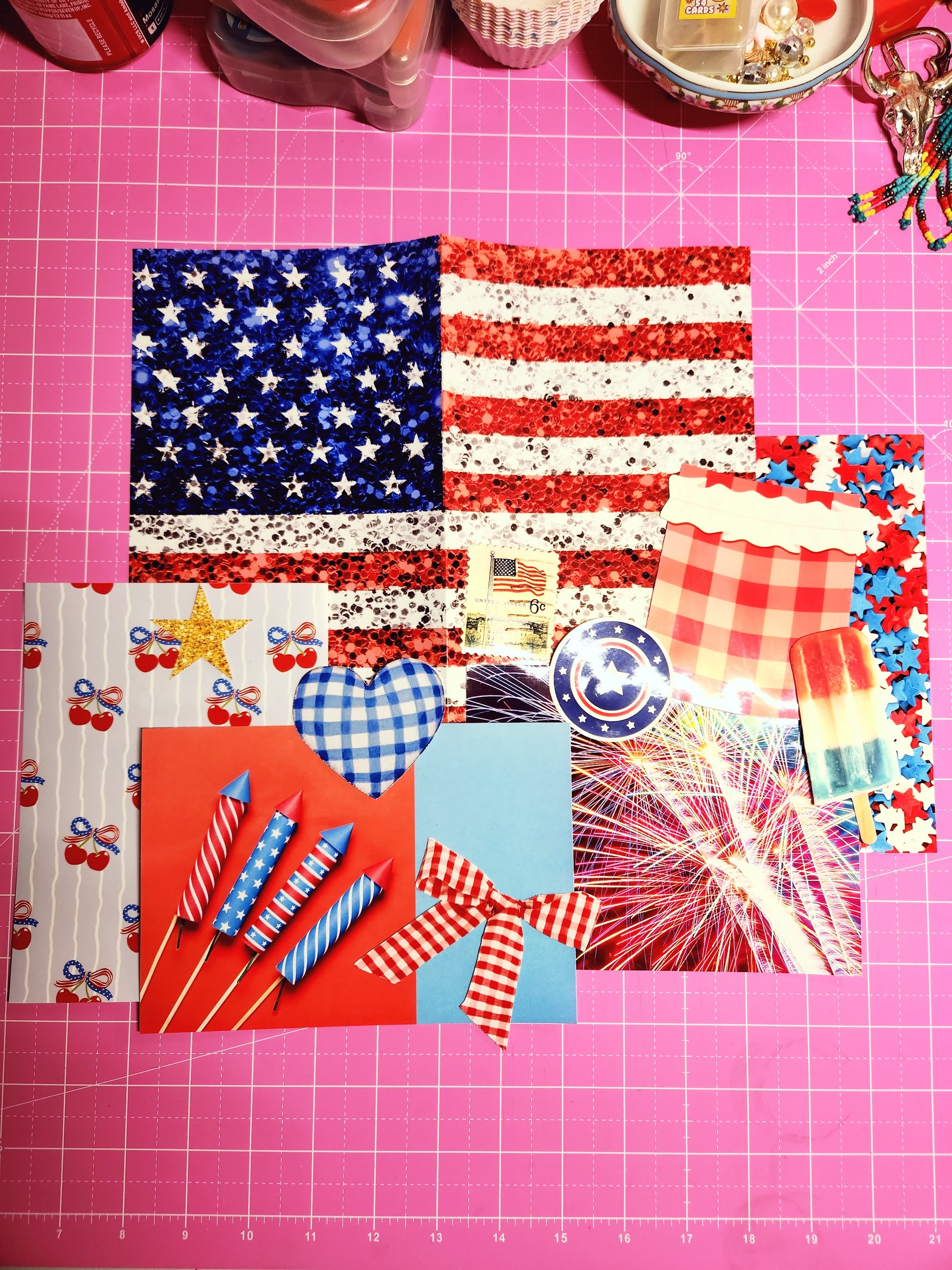 Collection of patriotic-themed stickers on a pink cutting mat with grid lines.