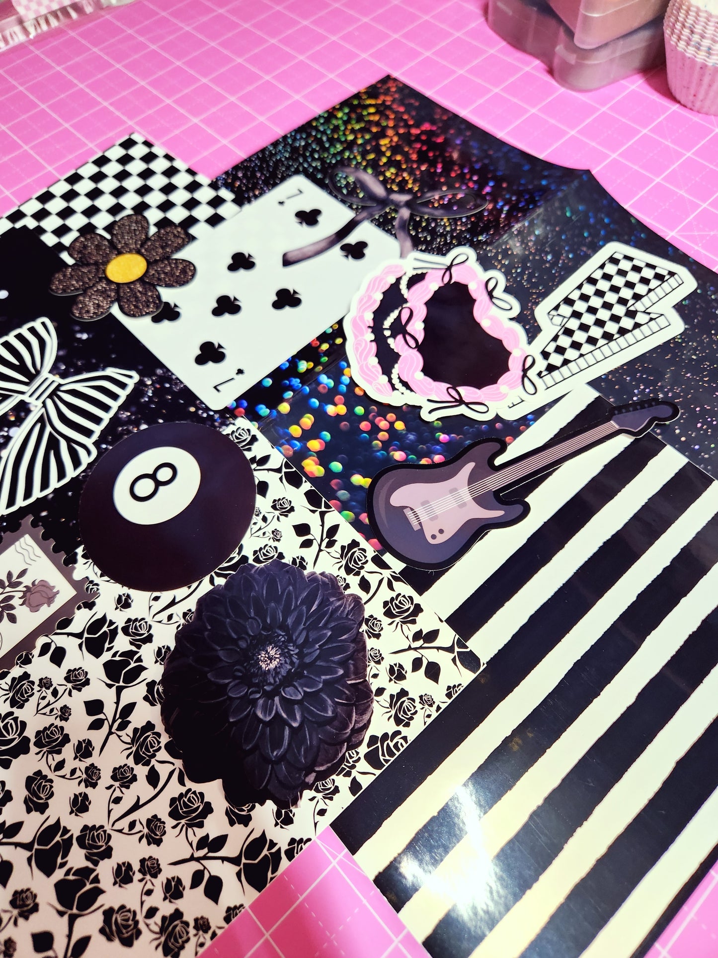 Collection of decorative stickers on a black and white striped background