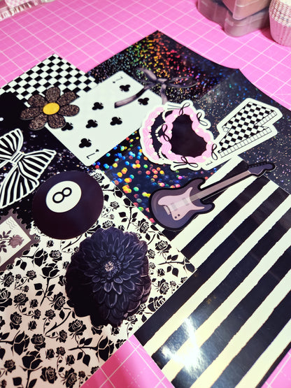 Collection of decorative stickers on a black and white striped background