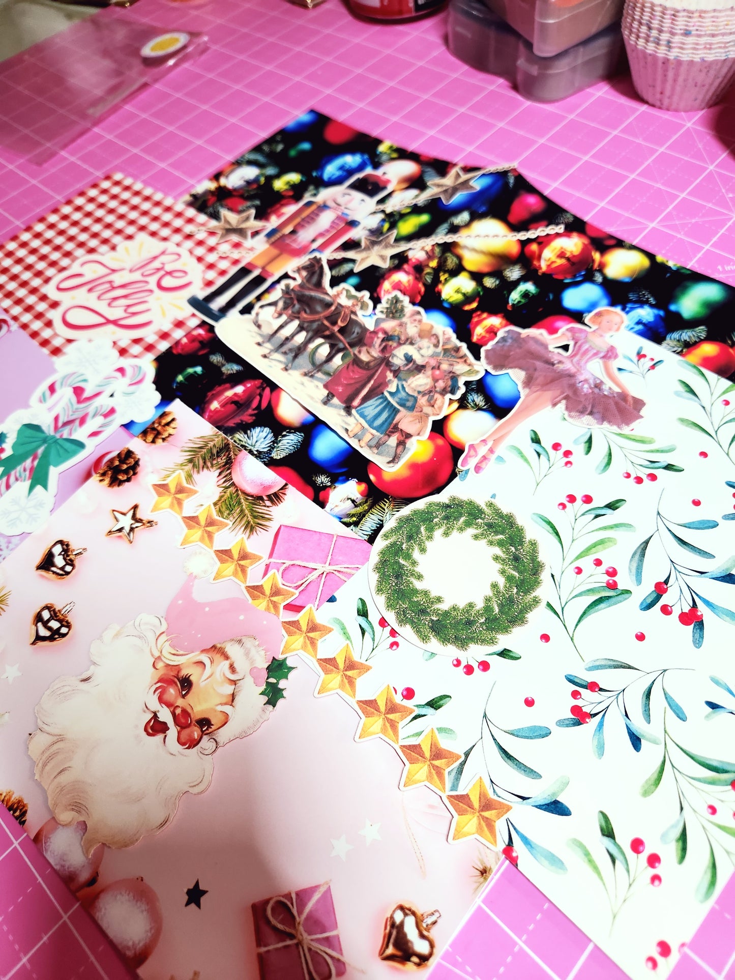 Collection of Christmas-themed stickers on a pink surface