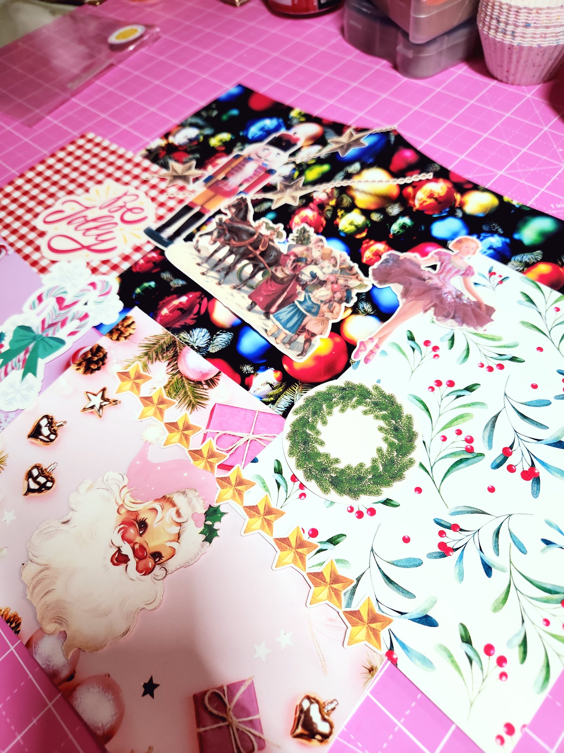 Collection of Christmas-themed stickers on a pink surface