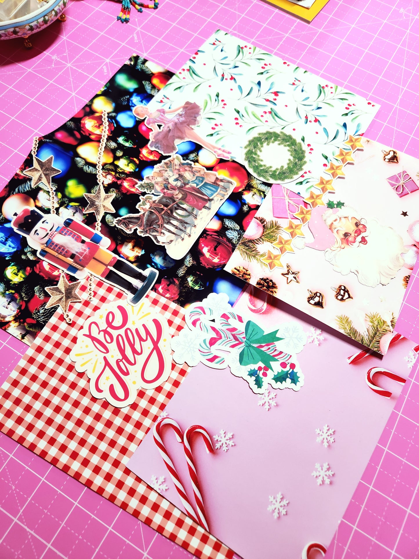 Collection of colorful paper cutouts on a pink cutting mat