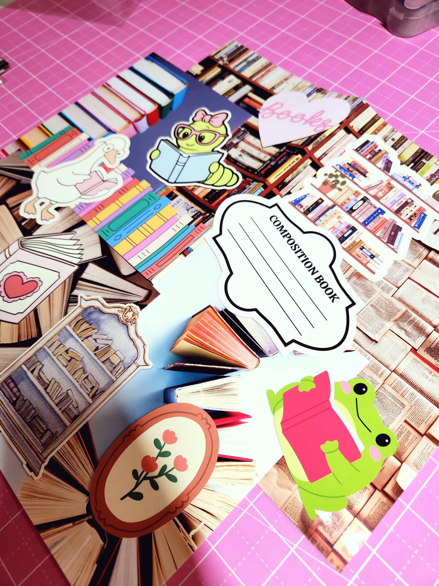 Collage of stationery items including a composition book, frog character, and decorative elements on a pink grid background.