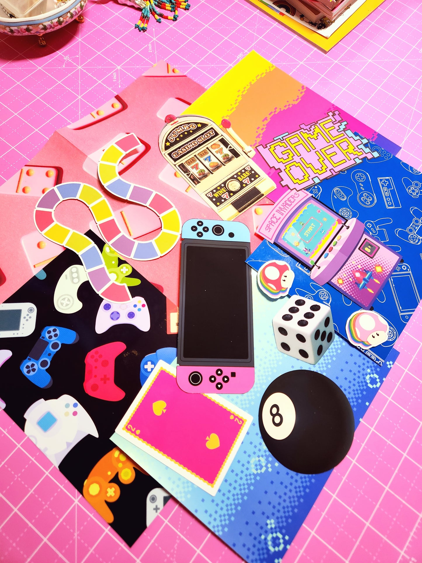 Collection of gaming-themed items on a pink and blue checkered surface