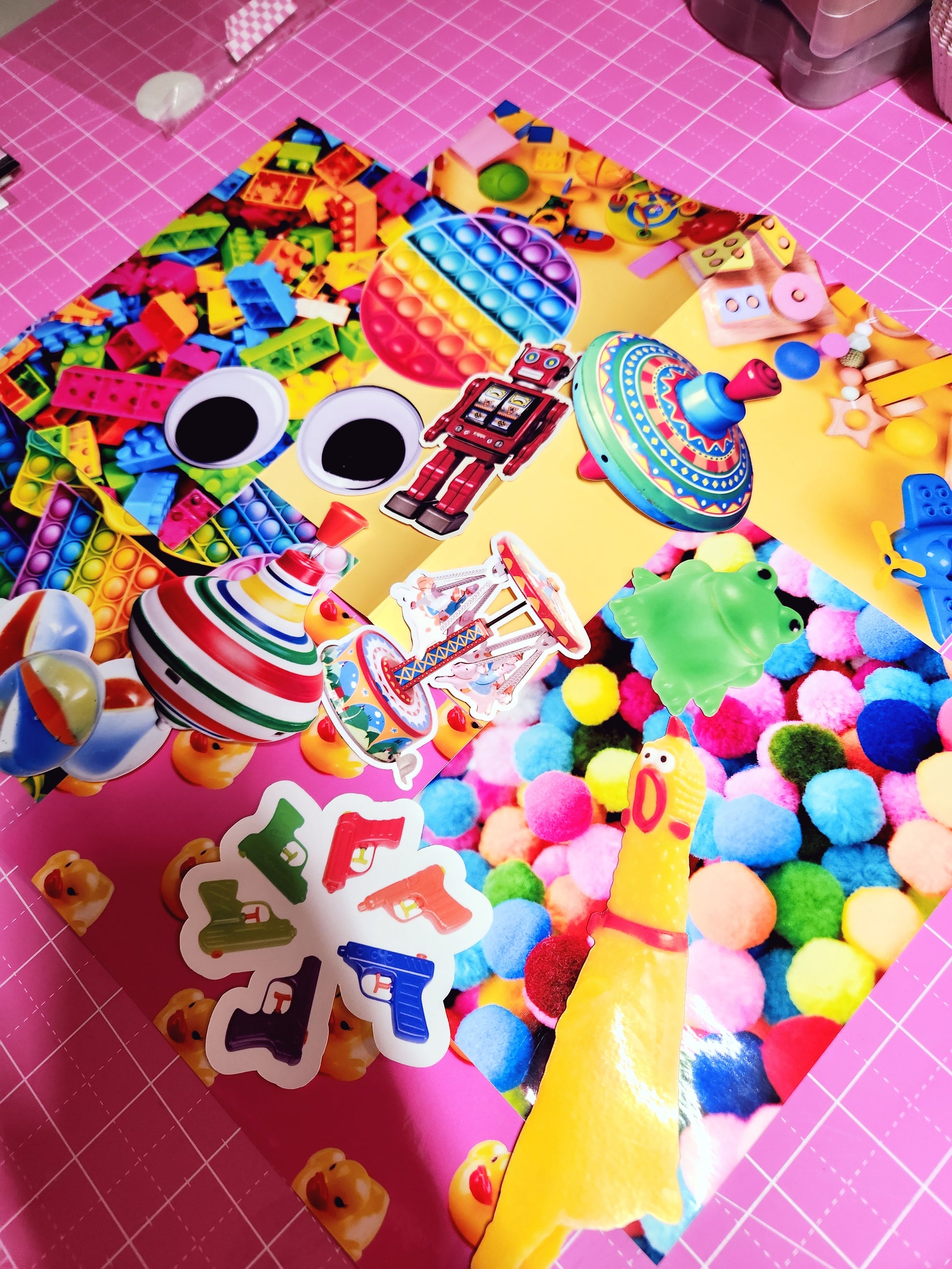 Colorful assortment of toys and play items on a pink grid background