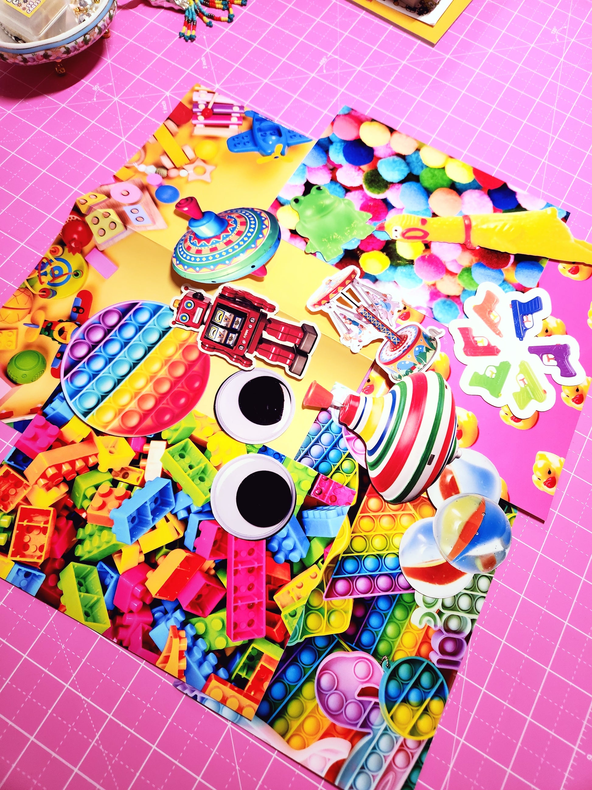 Colorful assortment of toys and novelty items on a pink grid background