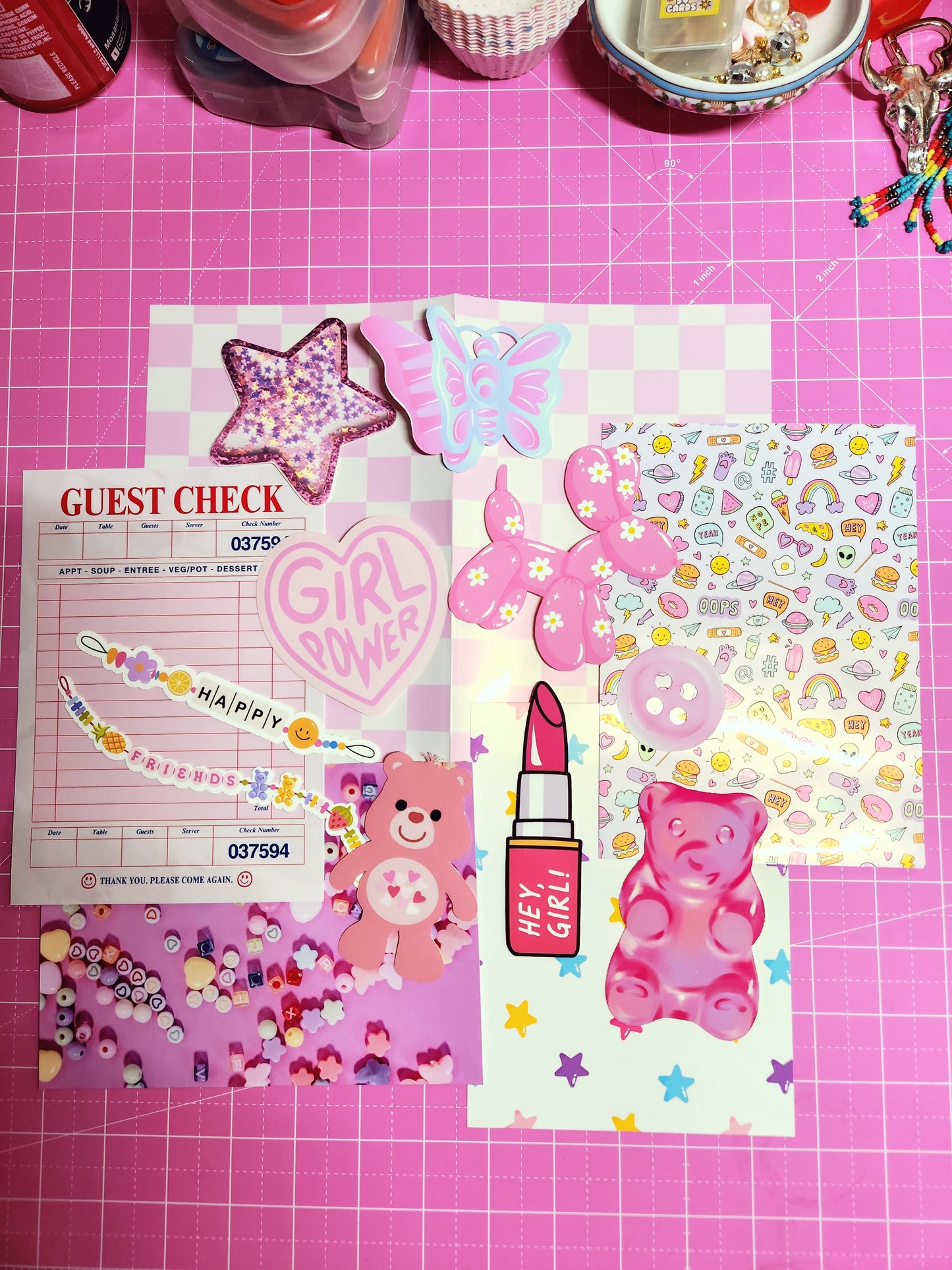 Collection of colorful stationery items on a pink grid background