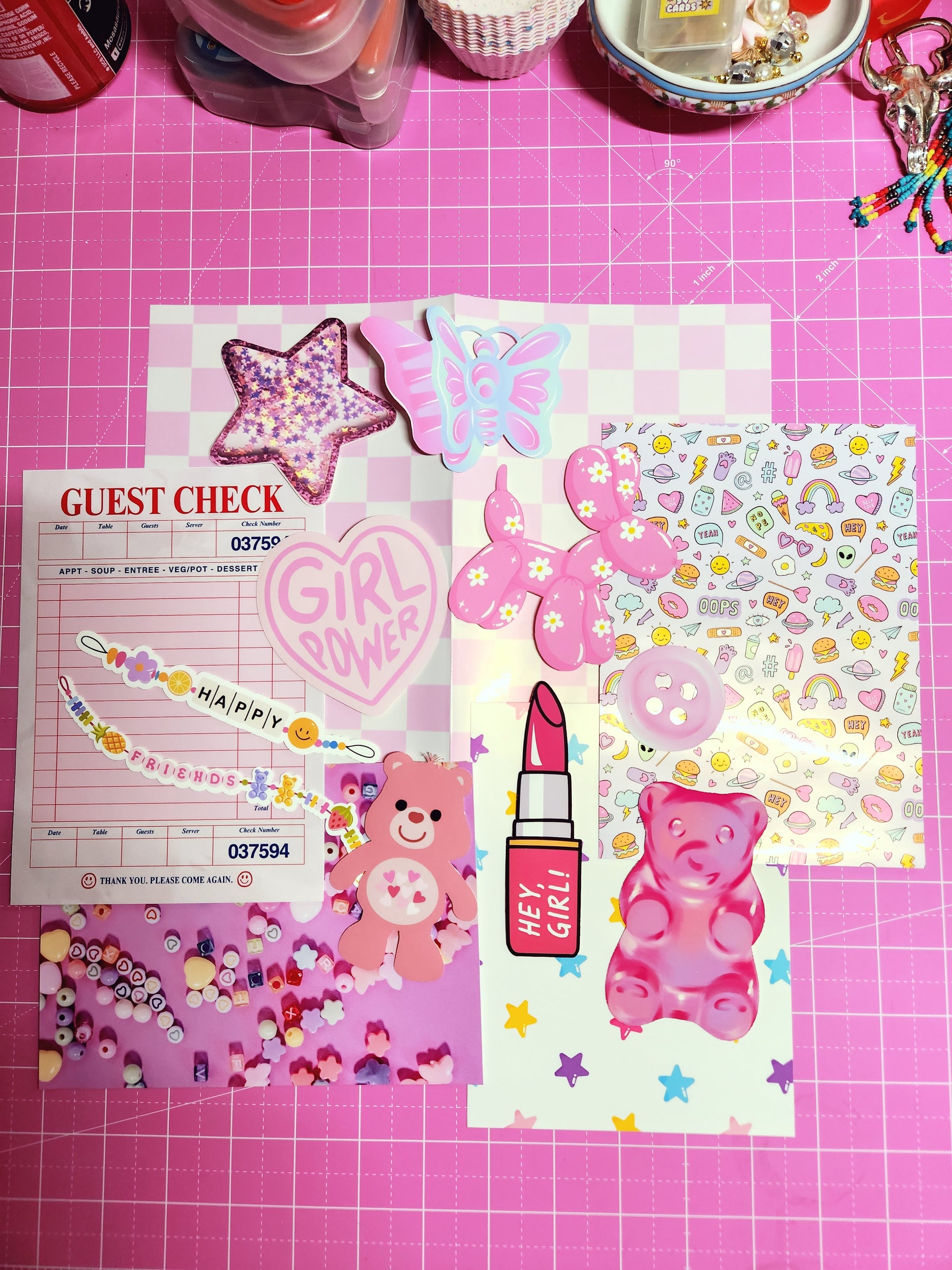 Collection of colorful stationery items on a pink grid background