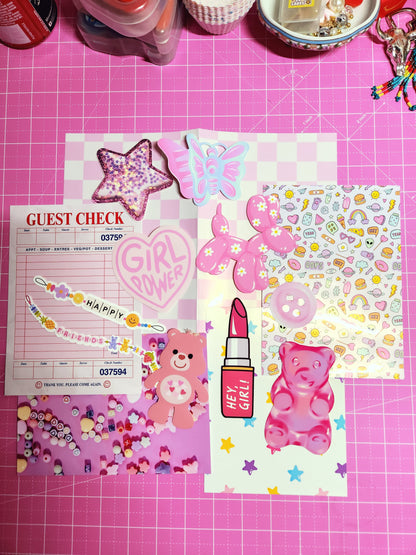 Collection of colorful stationery items on a pink grid background