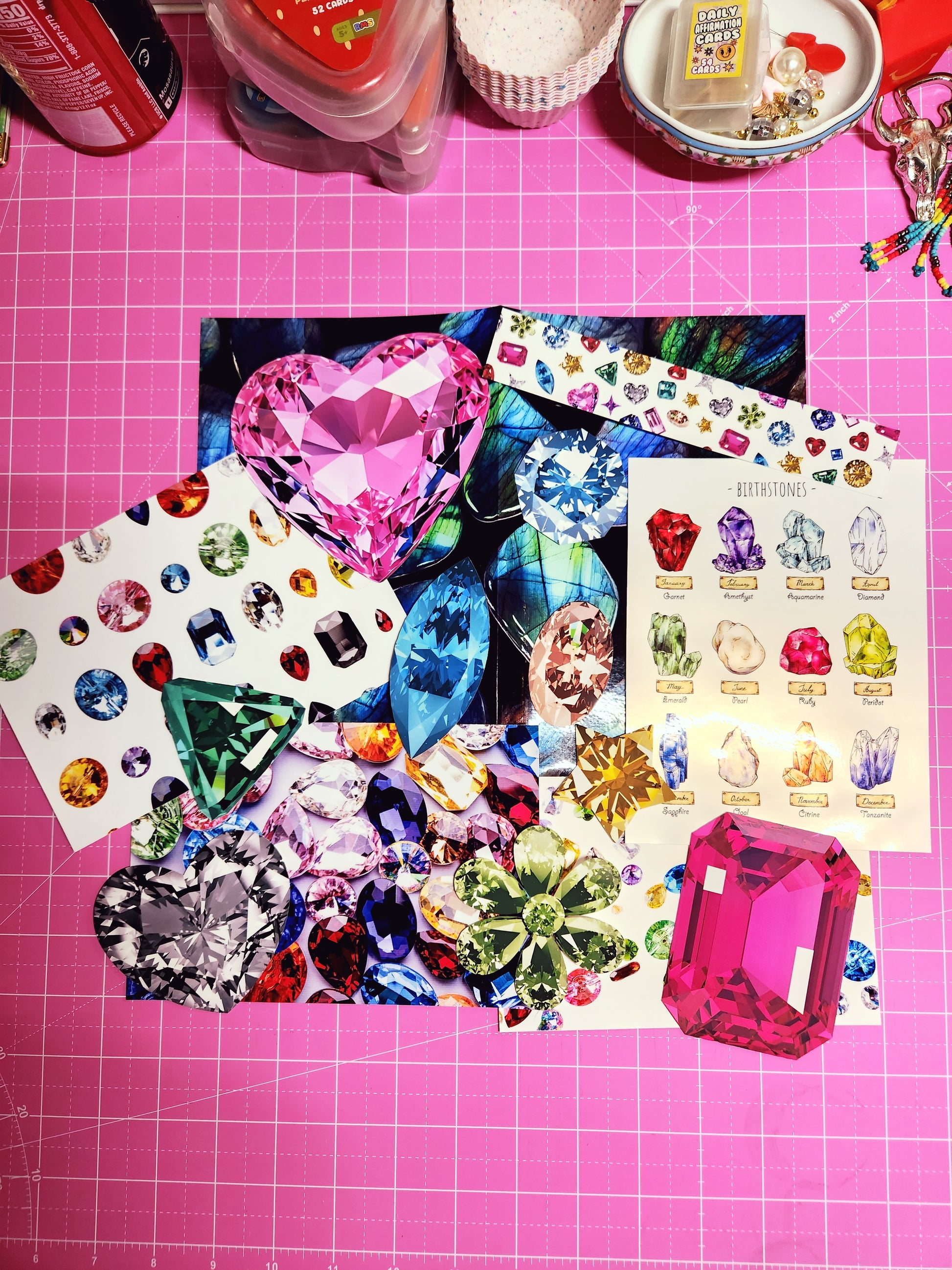 Colorful gemstone stickers on a pink grid background