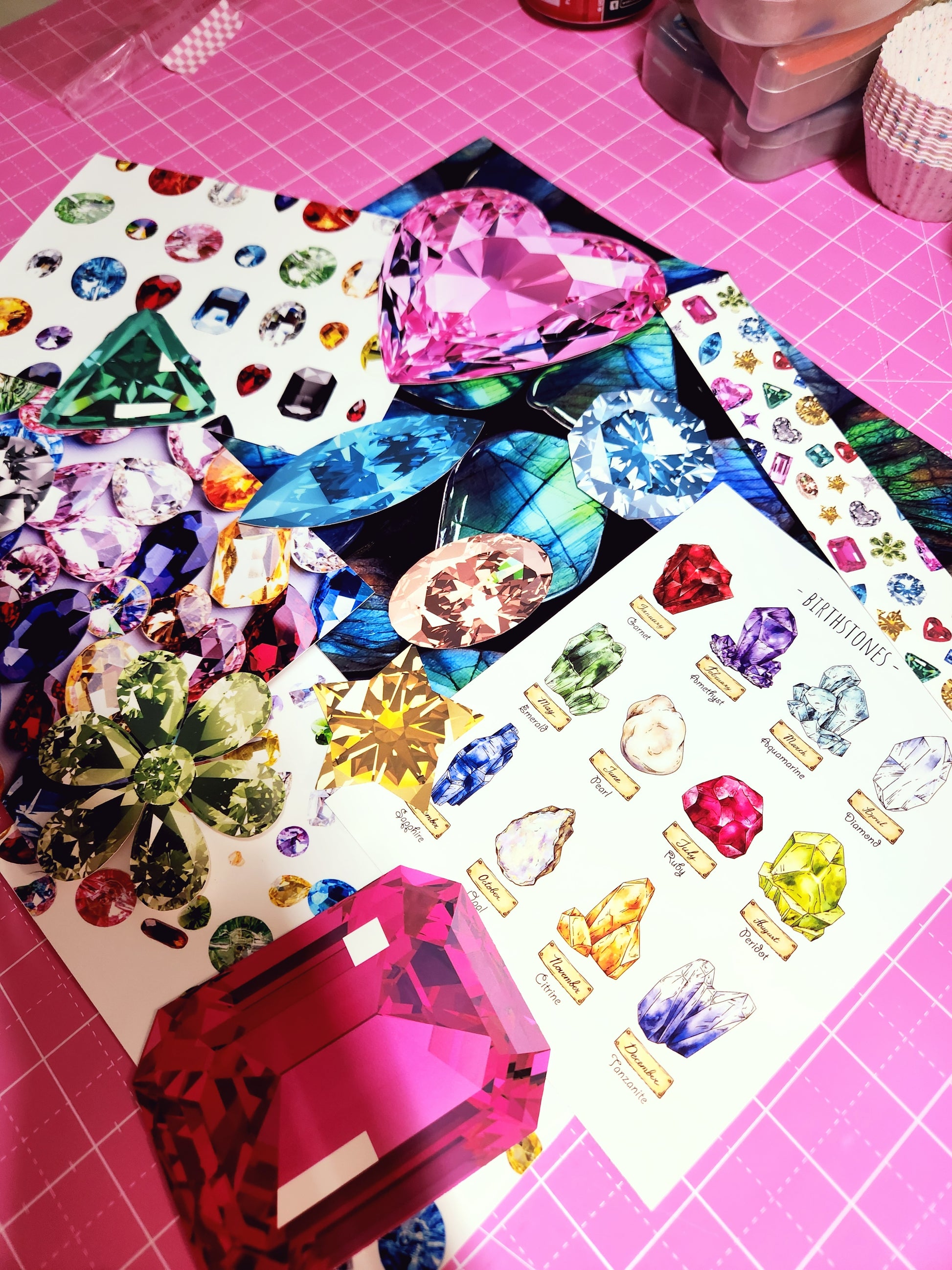 Colorful gemstone stickers on a pink cutting mat