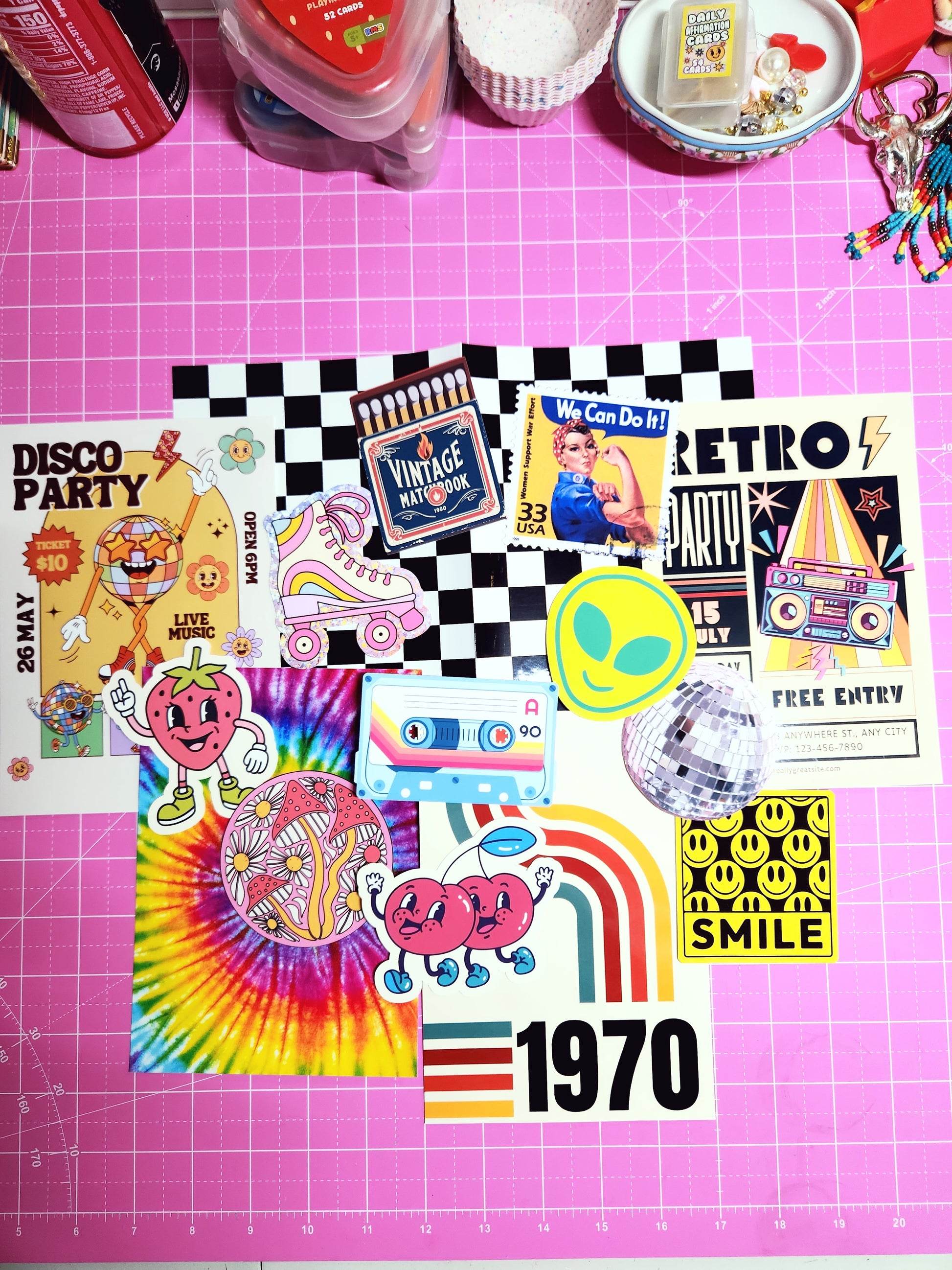Collection of colorful stickers on a pink cutting mat with grid lines