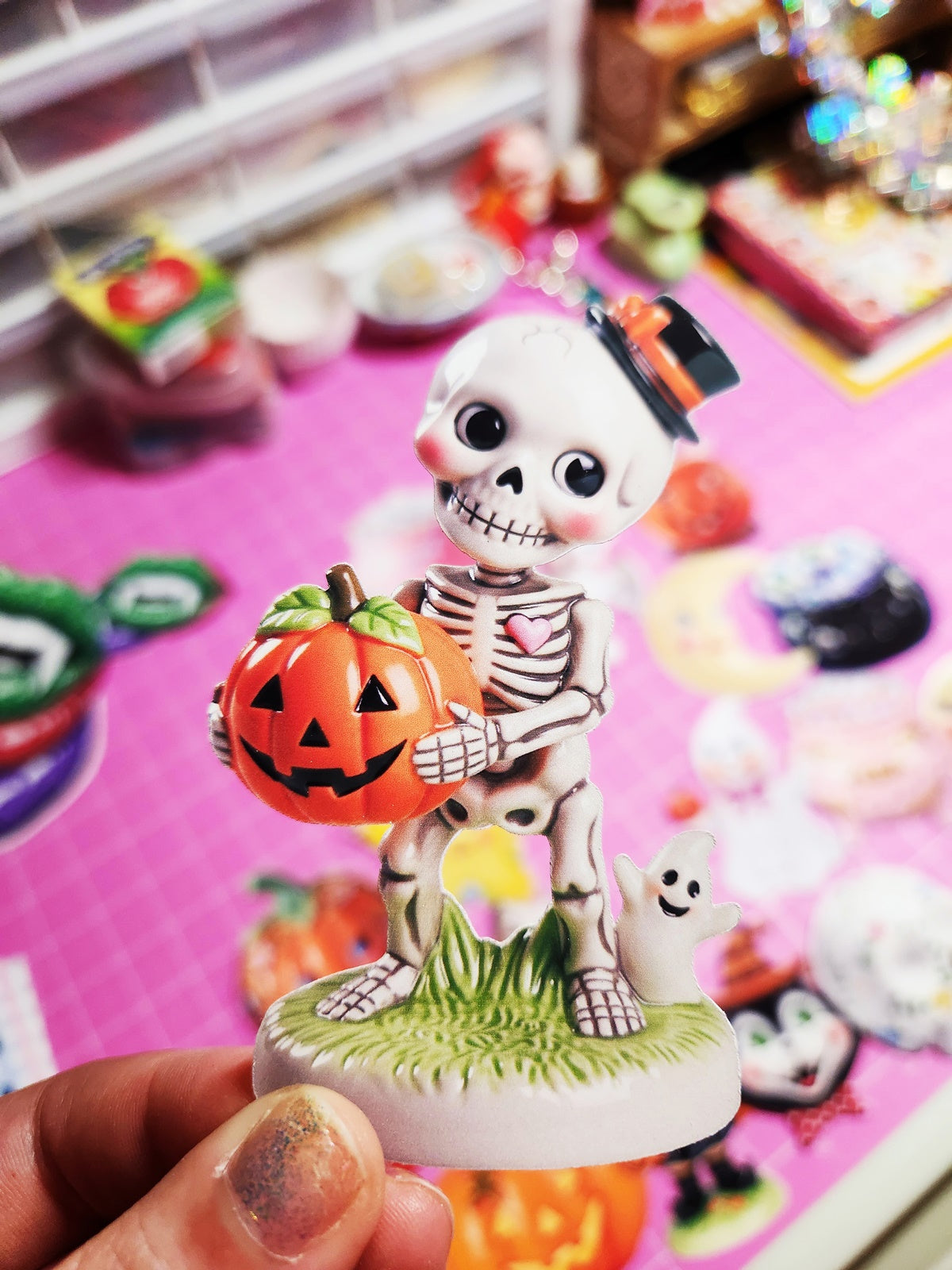 Skeleton figurine with a pumpkin on a colorful background