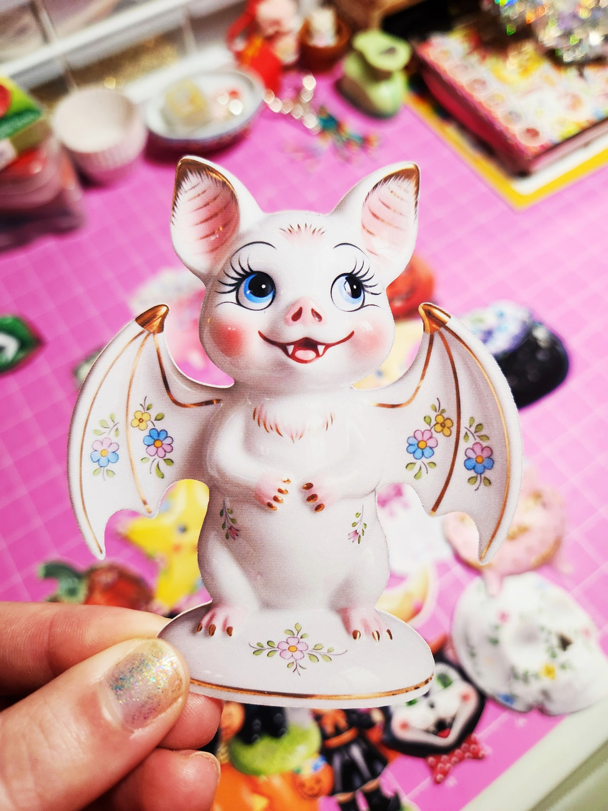 Decorative figurine of a cartoon pig with colorful design on a pink background
