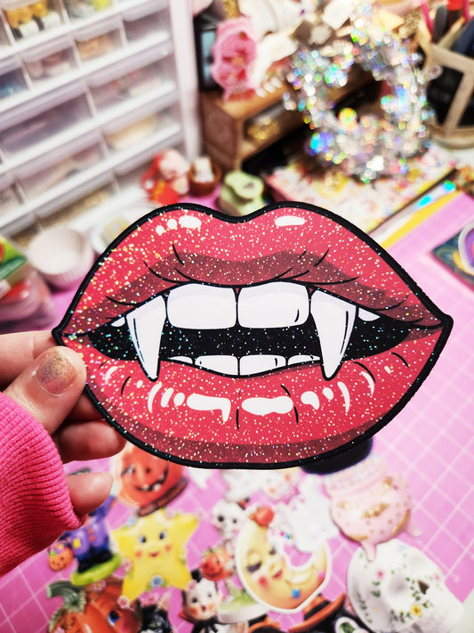 Vampire lips patch held by a person with a colorful background