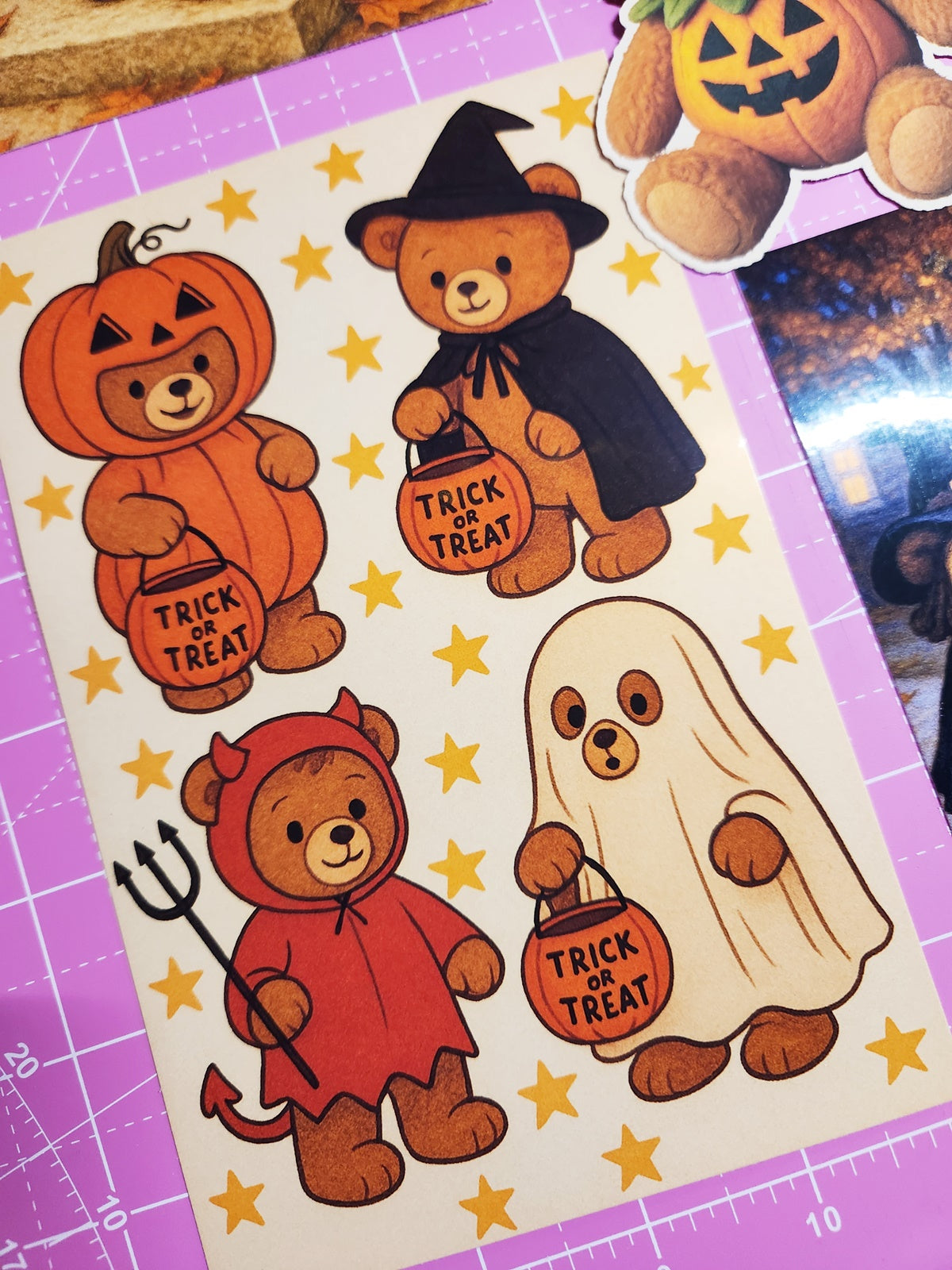Halloween-themed stickers of bears in costumes on a purple grid background