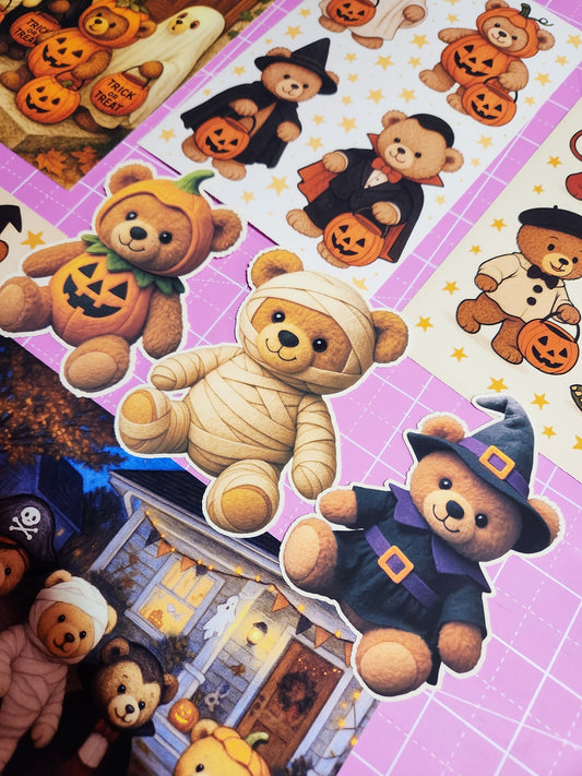 Halloween-themed teddy bears in costumes on a grid background