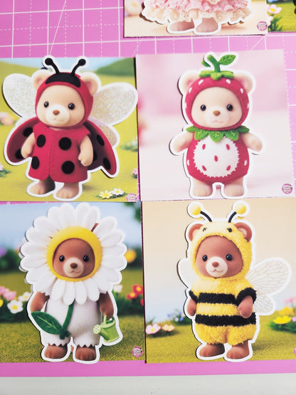 Four toy figures in different costumes on a pink background