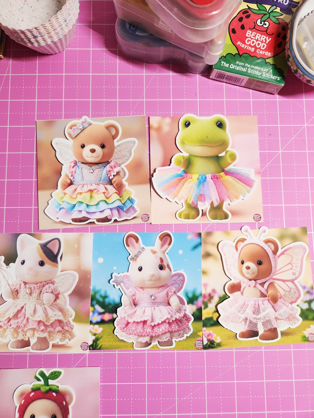 Collage of toy stickers on a pink grid background