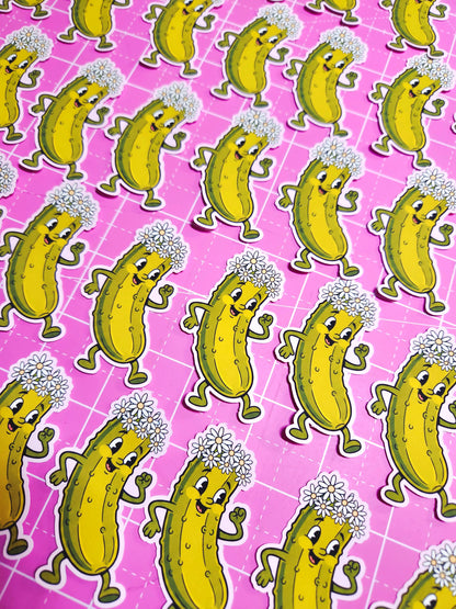 Pattern of cartoon pickles with dandelions on a pink grid background